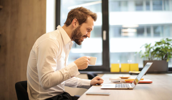 Man on laptop for webinar